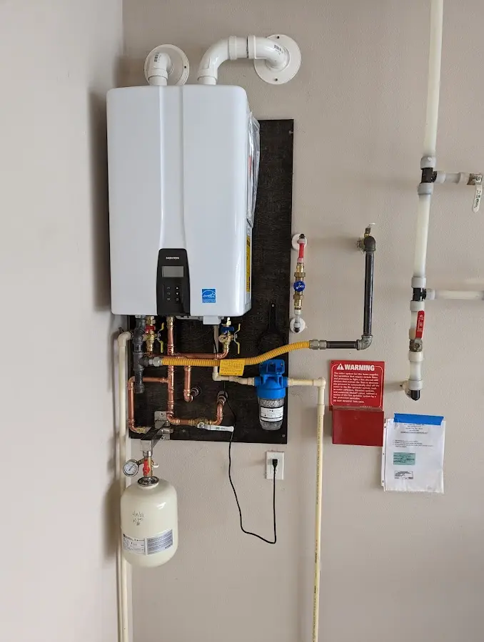 Professional plumber installing copper piping in a Lacombe home